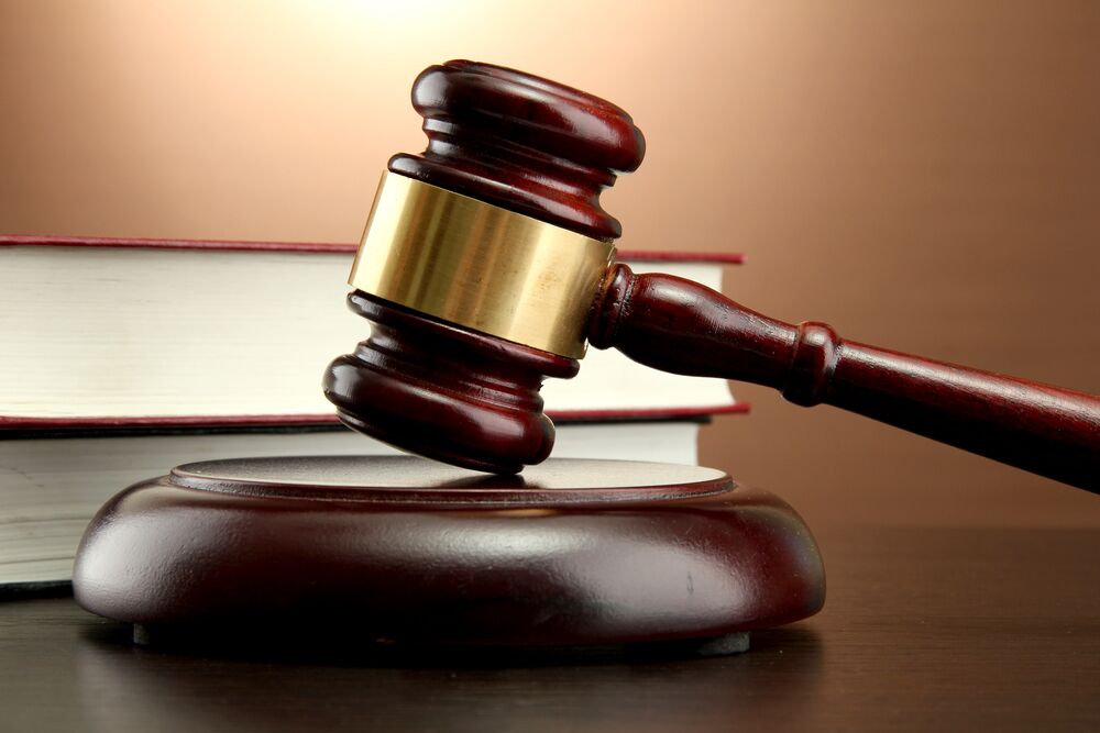 What Counts as Pain and Suffering in Court? - wooden gavel and books on wooden table, on brown background