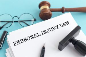 Personal-Injury-Lawyer-Woodland-Hills-CA-personal-injury-law-paperwork-with-gavel-and-glasses
